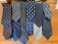 All twelve ties displayed side by side on table surface