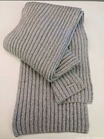 Full view of folded rib knit silver scarf