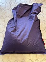 Full view of purple Fatboy bean bag laid flat