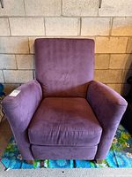 Front view of purple faux suede armchair showing seat, back, arms, and feet