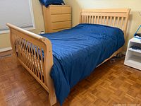 Full view of assembled beech sleigh bed frame with mattress showing headboard, footboard, side rails