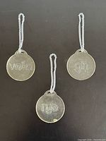 Front view of three Lucite tags labeled vodka gin rye
