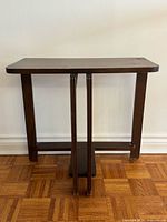 Front view of walnut Art Deco side table showing overall design and base details