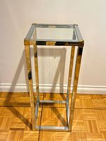 Full view of chrome and brass pedestal table