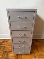Front view of grey metal 6-drawer cabinet