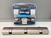 Sealed Weiser door knob package beside folding hanger rail