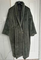 Full view of grey faux fur long coat on hanger