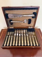 Open case displaying full 14-piece fish cutlery set