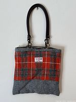 Full view of tote bag showing plaid pattern, label, and lower grey panel