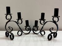 Pair of black wrought iron three-candle candelabras