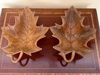 Two carved wooden maple leaf bowls top view