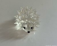 Front view of clear crystal hedgehog showing spikes and black eyes