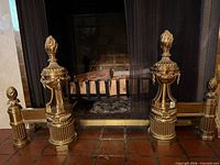 Full pair of brass andirons in fireplace