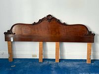 Full front view of walnut king headboard showing overall design and attached support legs