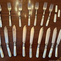 Full set laid out showing 9 knives, 7 forks and 4 spare handles