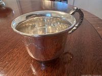 Oblique view of mug showing rolled rim, handle, and interior