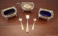 Full set showing two salt cellars, mustard pot and three spoons