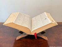 Dictionary open on carved wooden stand