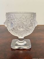 Front view of frosted crystal Lalique vase on square pedestal