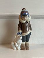 Front view of Lladro figurine showing boy petting bear cub