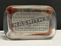 Top view of glass paperweight showing full advertising text