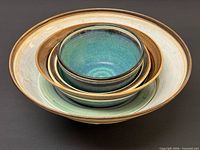 Nested view of all five signed Mayta Markson pottery bowls