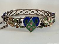 Front view showing enamel heart and floral design