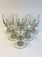 Front angled view of six clear heavy hand-blown water goblets