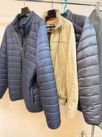 Three jackets on hangers showing colors and styles