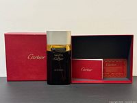 Bottle, box, booklet and card arranged