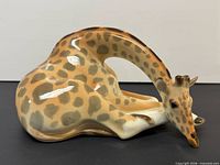 right-side view of reclining giraffe porcelain figurine