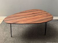 Full view of the tripod coffee table showing wood top and three hairpin legs