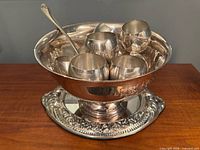 Full set on table: bowl on mirror tray with cups inside