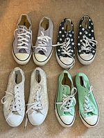 All four pairs of Converse sneakers arranged side-by-side