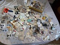 Overview of entire spread of vintage buttons on table