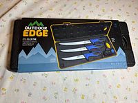 Retail packaging showing Outdoor Edge ReelFlex Pak set