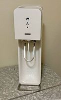 Front view of white Sodastream Source unit standing on counter