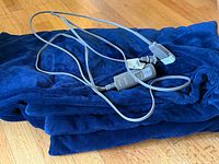 Folded navy blue heated blanket with attached grey control cord