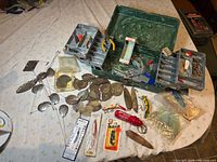 Overall lot showing tackle box, lures and accessories spread on table