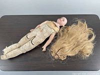 Full view of doll body and detached wig