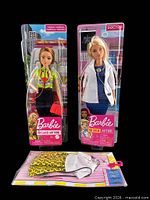 Front view of both sealed dolls and outfit pack