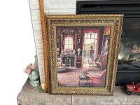 Framed print leaning against hearth showing entire artwork and frame