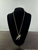 Full view of necklace on display bust showing chain length and pendant