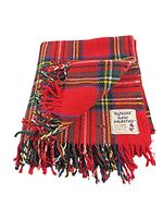 Folded red tartan wool throw showing fringe and label