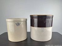 Front view of both stoneware crocks showing markings