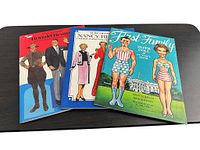 Front covers of all three paper-doll books displayed side-by-side