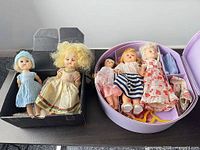 Group of six dolls in boxes with accessories