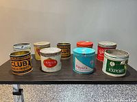 All nine tins grouped on table