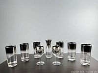 Full set of nine silver fade glassware pieces arranged on table