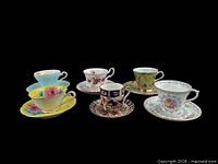 All six teacup and saucer pairs lined up